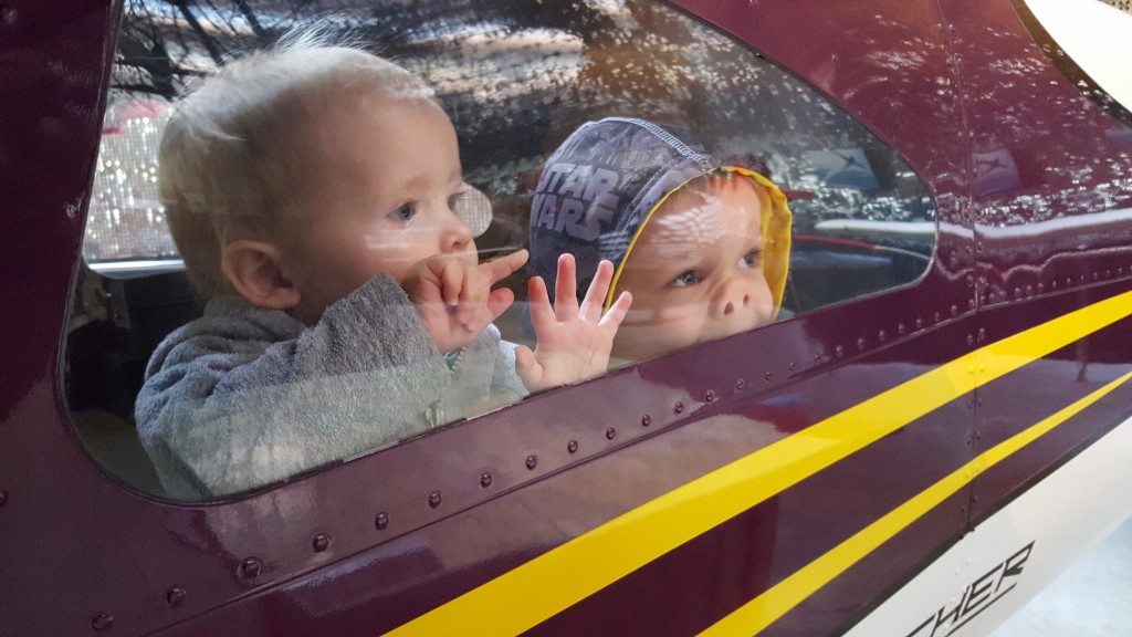 Callan and Nolan in a plane at Exploration Place