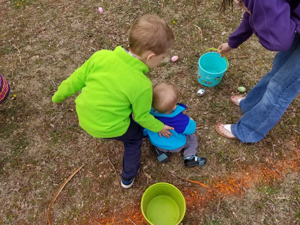 Nolan helping his brother Callan at the Easter egg hunt