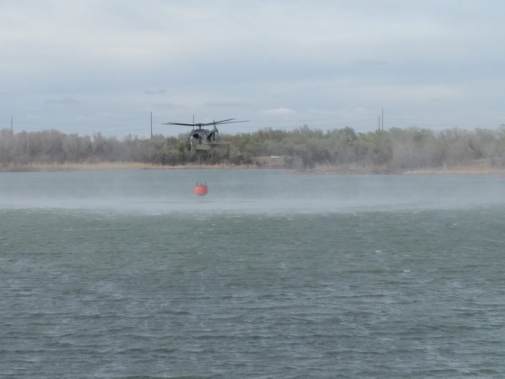 Black Hawk helicopter loading water to fight fires